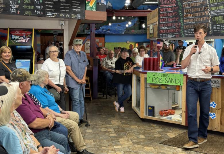 Rob Sand speaks to residents at town hall hosted at Borderline Pizza in Forest City